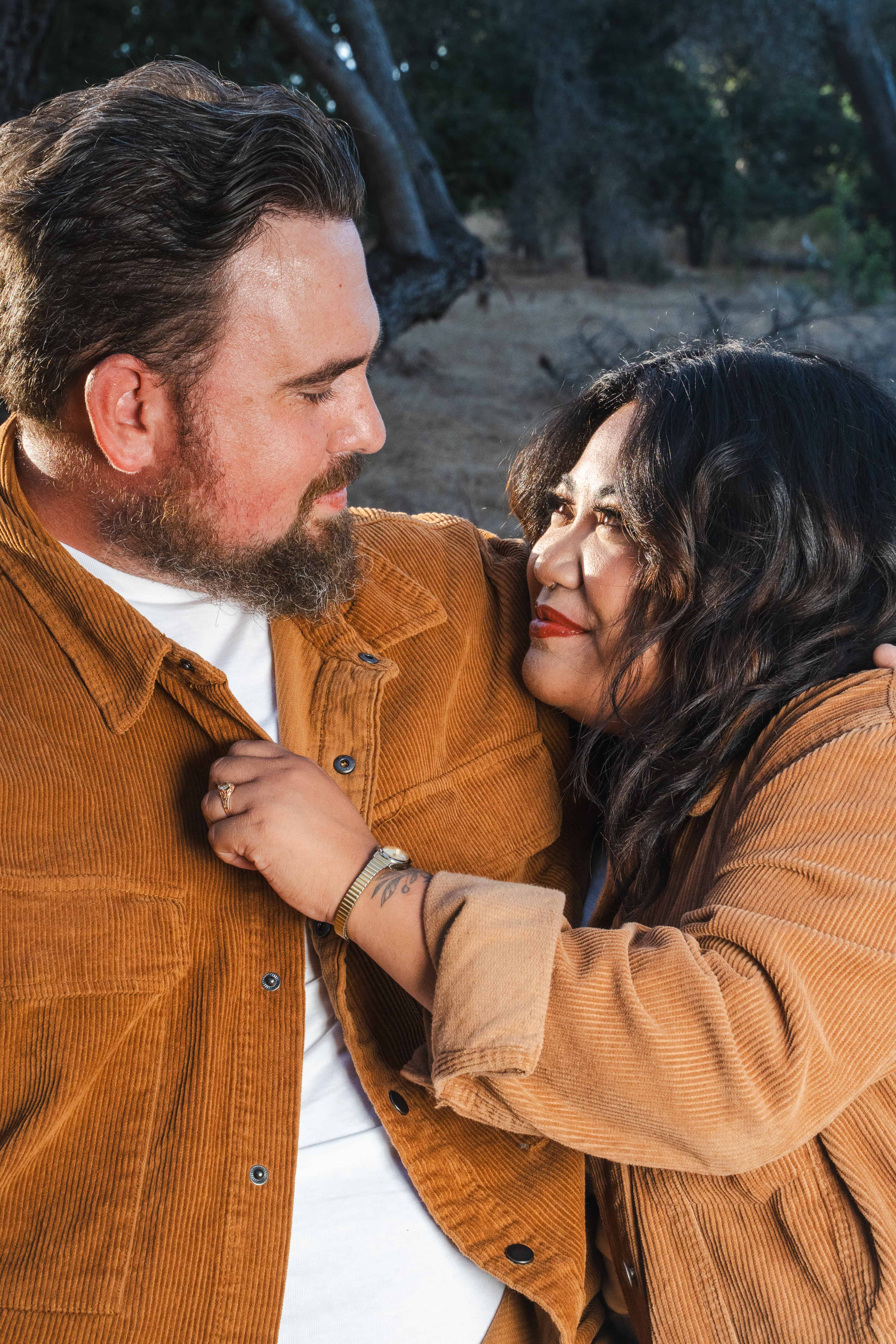 Couple's portrait shoot at felicita park looking into eachother's eyes with love.